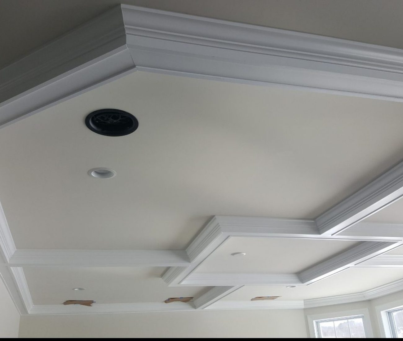 Detailed coffered ceiling trim installation with recessed lighting in progress, showcasing clean white crown molding and precise craftsmanship — completed by Central Connecticut Building & Remodeling in Berlin, CT.
